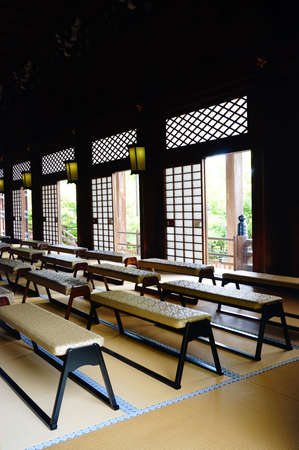 In a corner of the hall chanting in the Golden Pavilion,Japan