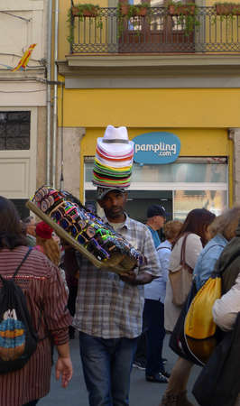 Valencia, Spain - March 16 2017: A wandering salesman sells hats and sunglasses during las fallas festivalのeditorial素材