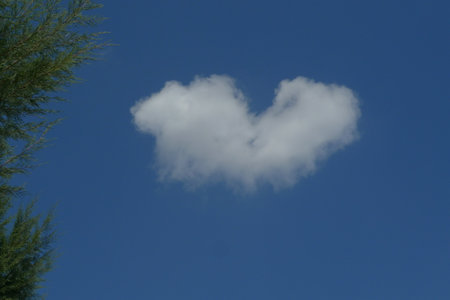 Blue sky and white clouds in the shape of a heartの写真素材