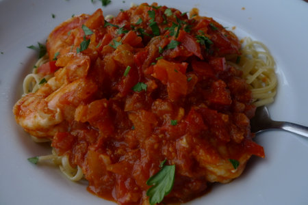 Spaghetti with prawns, tomato sauce and fresh parsleyの写真素材