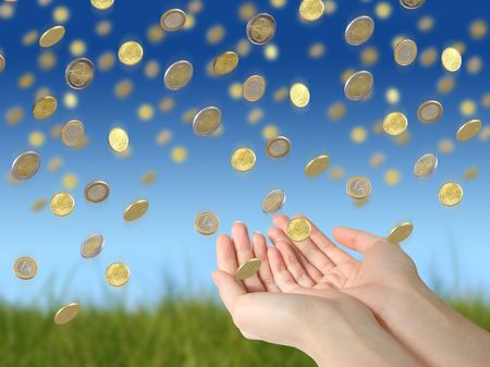 Coins falling to hands over blue sky background. の写真素材