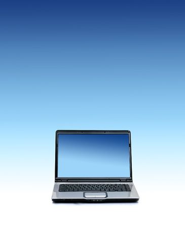 New laptop with empty screen. Over blue sky background.の写真素材