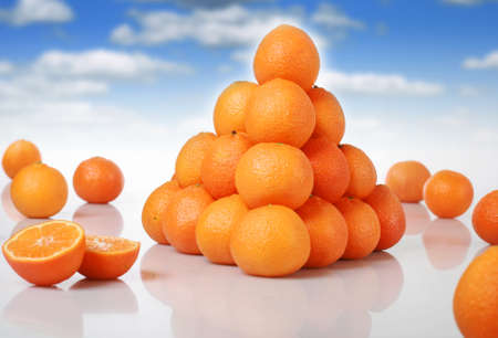 Fresh oranges over blue sky background.の写真素材