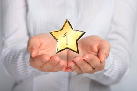 Golden star in hands  Number one の写真素材