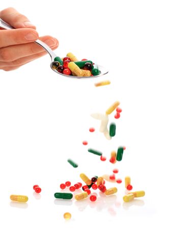 Colorful pills isolated over white の写真素材