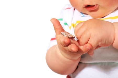 Baby and coin isolated over white.の写真素材