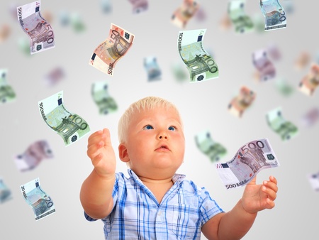 Young businessman. Kid and a lot of money.の写真素材