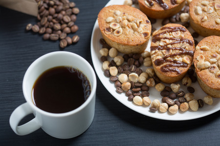 White cup of coffe and cookies in a white plateの写真素材