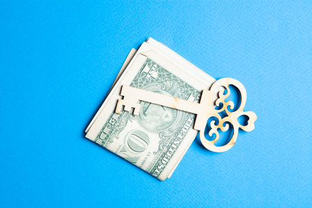 keys and money on a blue background