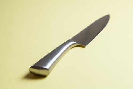 steel knife on yellow backgroundの写真素材