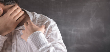 the young guy has a sore neck .の写真素材