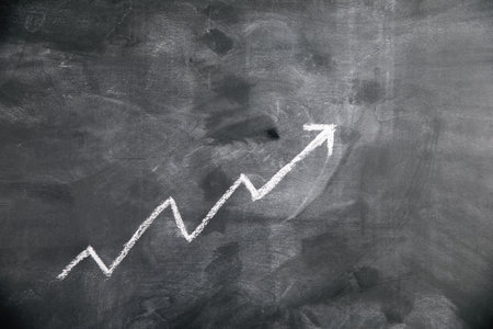 up arrow graph drawn on chalkboard .