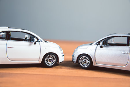 two toy car crash on a wood tableの写真素材