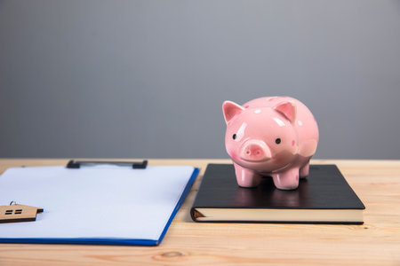 piggy bank and paper on the tableの写真素材