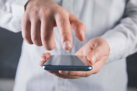 young man pressing a phone sensor .