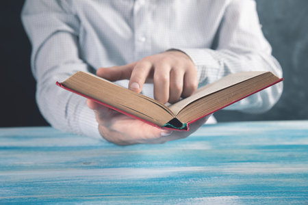 young man reading a book .