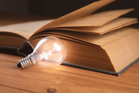 light bulb and book on the table new ideasの写真素材