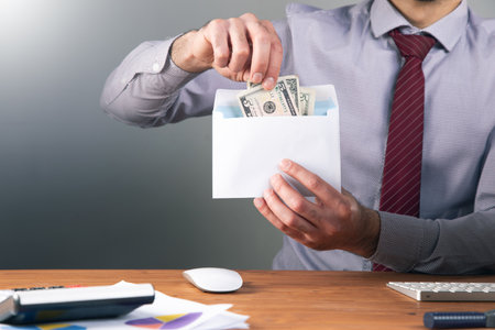 a man takes money out of an envelope .の写真素材