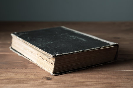 old book on the table .