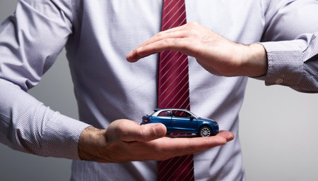 a man holding a toy car .の写真素材