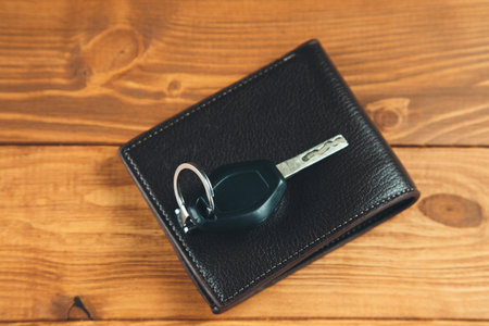 leather wallet and car key on the tableの写真素材