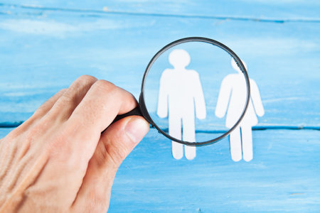 magnifying glass examines the icons of people.の写真素材