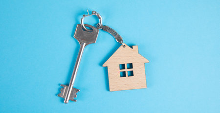 house keys with keychain on blue background