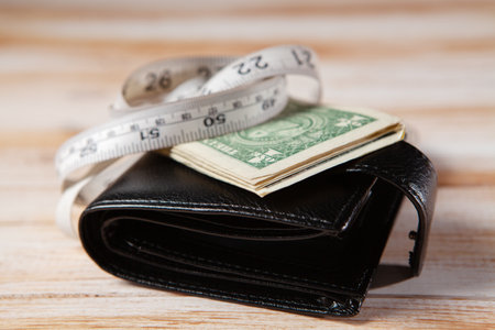 meter and wallet on a yellow backgroundの写真素材