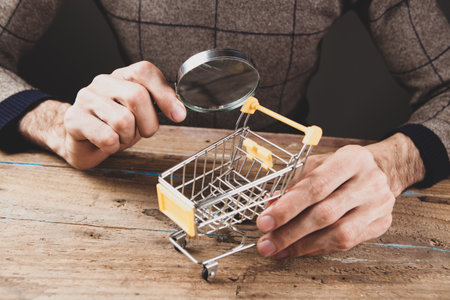 shopping search concept. magnifying glass looking at the basketの写真素材