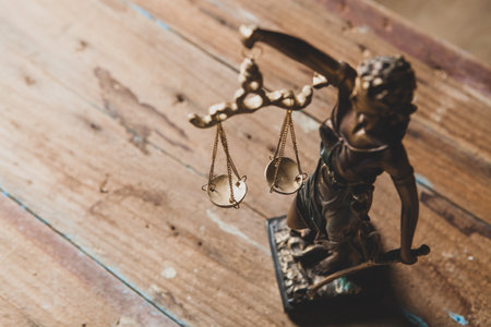 statuette of lady justice on wooden backgroundの写真素材