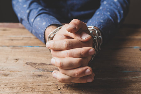 the man sits in chains. prisoner conceptの写真素材