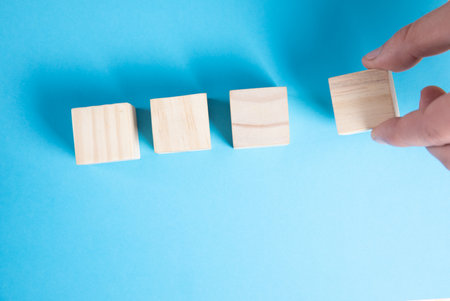 Top view of wooden cubes for text on blueの写真素材