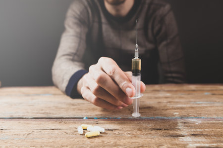 drug addict holding a syringeの写真素材