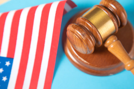 america flag and judge gavel on blue backgroundの写真素材