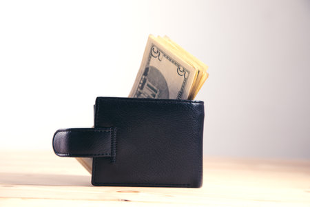 dollars and wallet on gray background