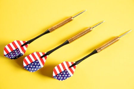 American flag darts on yellow background