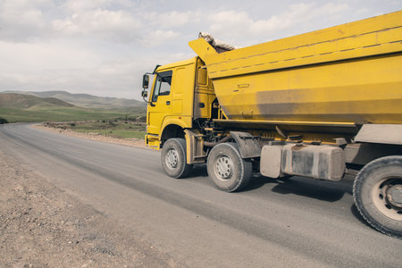 big yellow dump truck on the highwayの写真素材