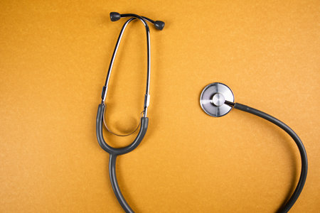 gray stethoscope on yellow backgroundの写真素材