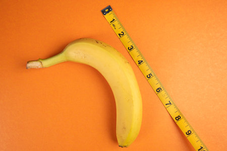 banana and meter on orange background
