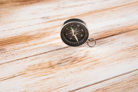 compass on a wooden background with a white shade