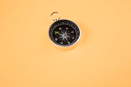 compass on isolated orange backgroundの写真素材