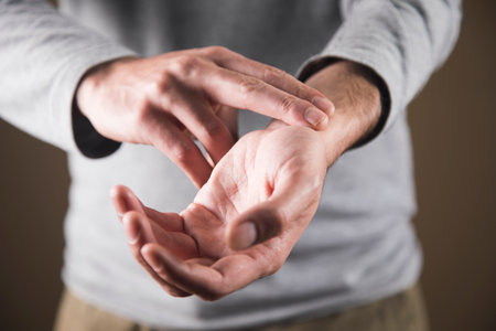 a man checks his pulse at his wristの写真素材