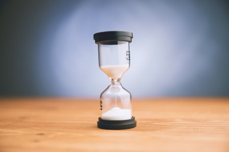 hourglass on table on gray background