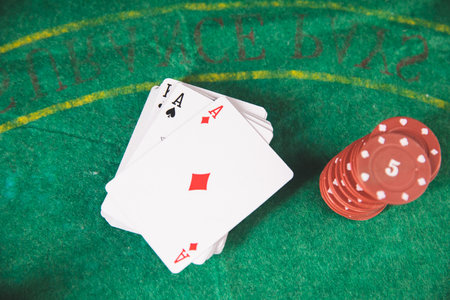 poker chips and cards on a green mat