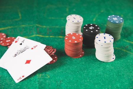 poker chips and cards on a green mat