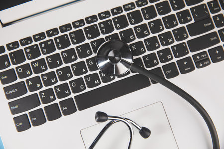 medical stethoscope on silver laptopの写真素材