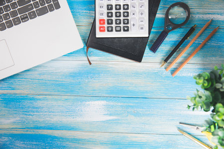 desktop, headphones, magnifier, calculator, laptop and pencilsの写真素材