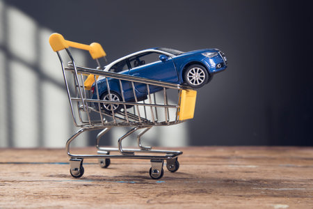 car in a basket on a wooden backgroundの写真素材