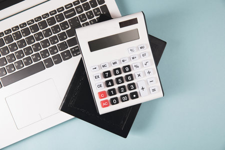 calculator, notepad and laptop on the table