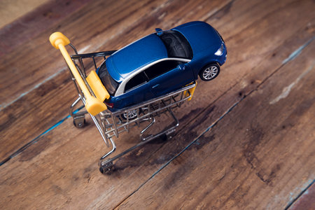car in a basket on a wooden backgroundの写真素材